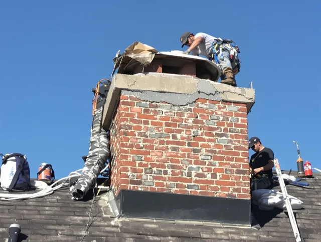Hudson Chimney Sweep installing a custom chimney crown in Hudson, MA