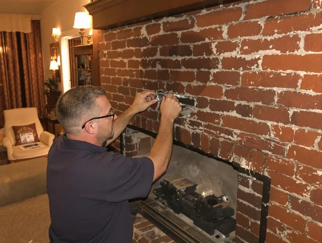 Hudson Chimney Sweep expert fixing a fireplace in Hudson, MA